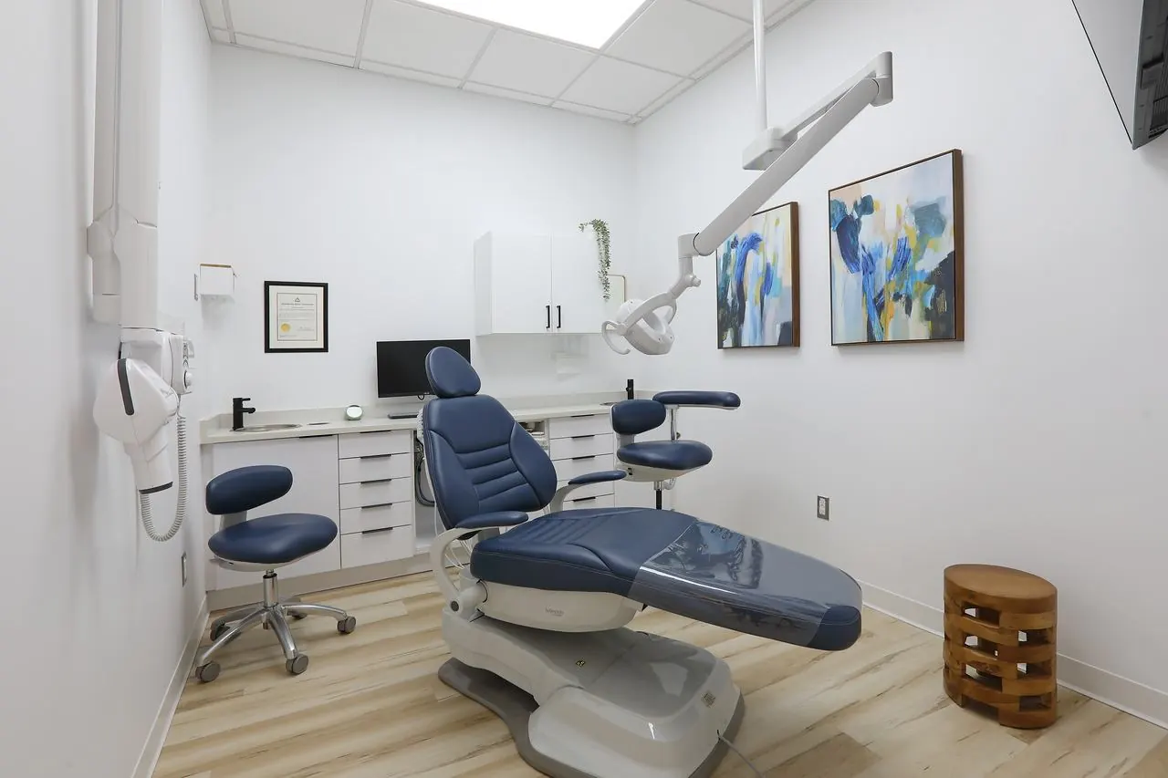 A bright treatment room with a dental chair at Radiant Dental